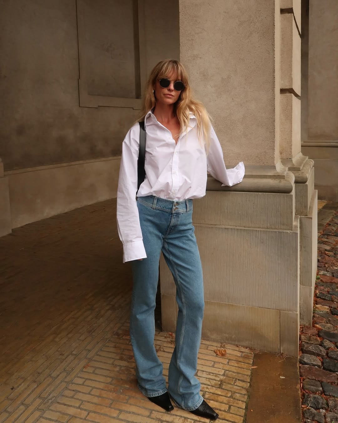 woman wearing slim-flare jeans with white button-down shirt