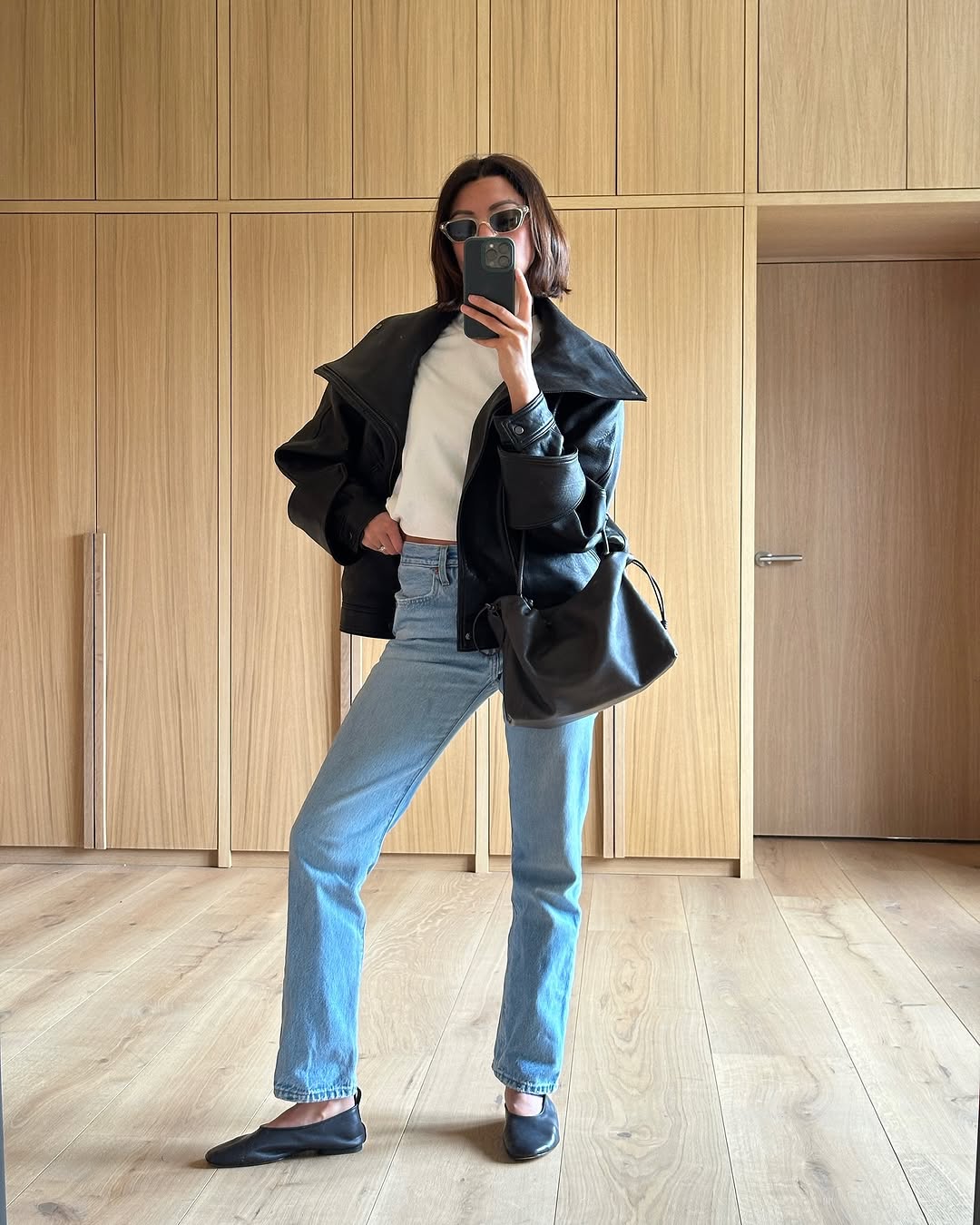 woman wearing vintage levis jeans and leather bomber jacket