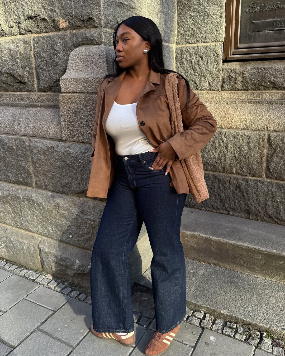 Woman wearing brown sneakers.