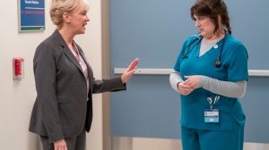 A nurse and a hospital administrator speaking in the hallway; Wendi McLendon-Covey and Allison Tolman in 'St. Denis Medical'