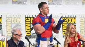 James Gunn, John Cena, Jennifer Holland at the "Peacemaker" sneak peek and panel at the 2025 Comic-Con International: San Diego held at the San Diego Convention Center on July 26, 2025 in San Diego, California.