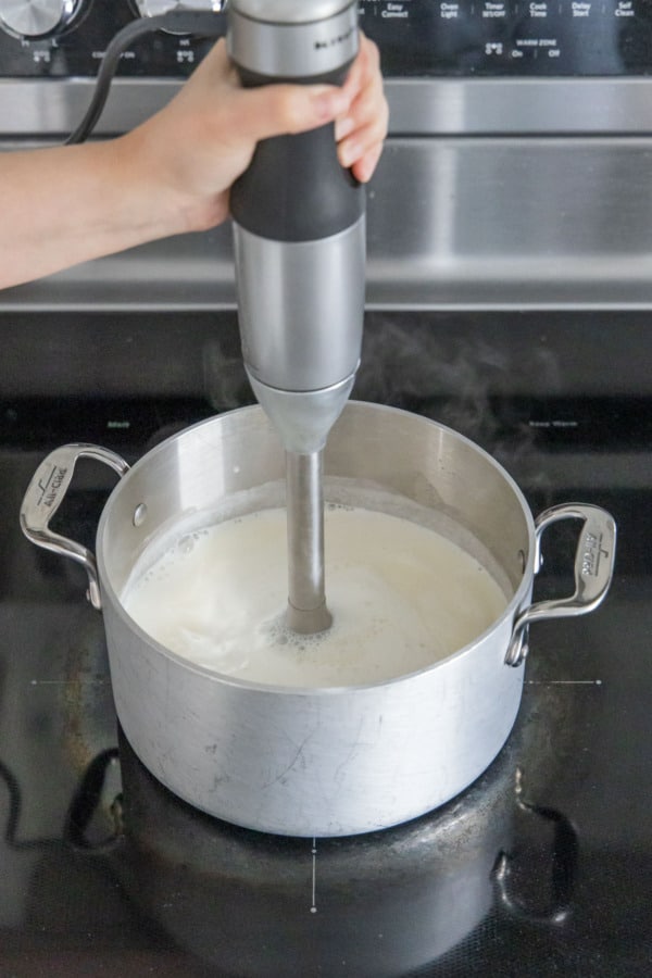 Blending the ice cream base with an immersion blender.